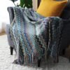 Selimut Allyssa warna biru 130x170 cm digunakan sebagai throw blanket di sofa