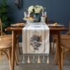 Table runner Camilla warna putih dengan motif floral di meja makan