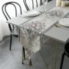 Table runner Russelia warna off white dengan motif floral di meja makan