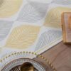 Detail kain dan motif daun table runner Vasa warna kuning